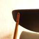 Pair of modernist Scandinavian chairs in teak and black faux leather.