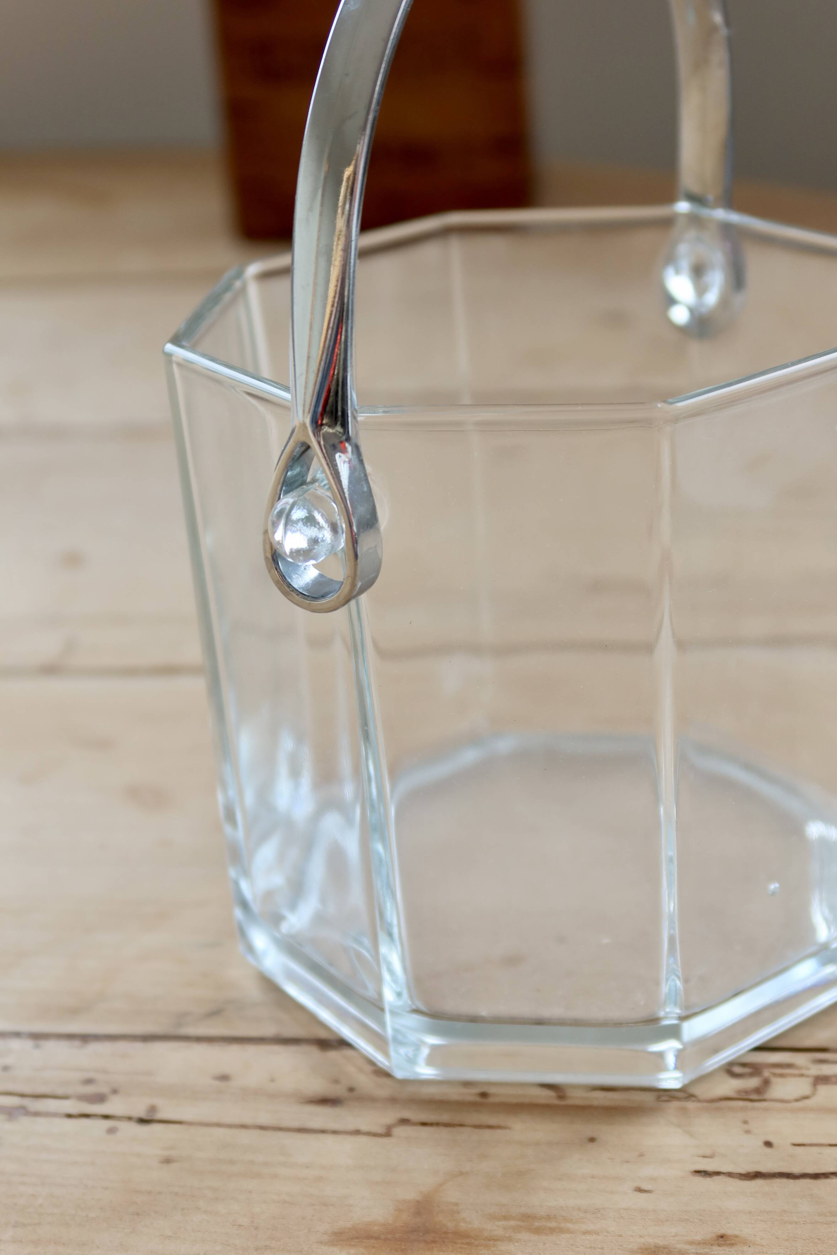 Vintage glass ice bucket with chrome handle.