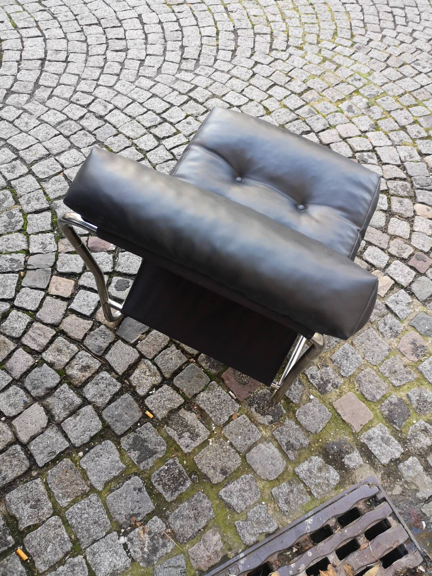 Tubular fireside chair in black skai and metal, design 1970