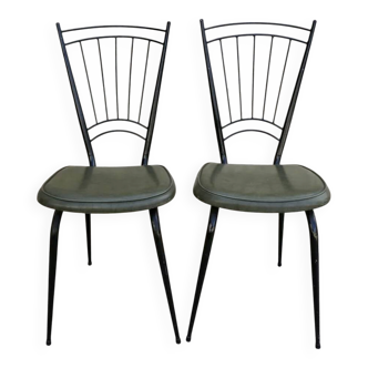 Black metal chairs with khaki faux leather seats, circa 1960.