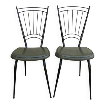 Black metal chairs with khaki faux leather seats, circa 1960.