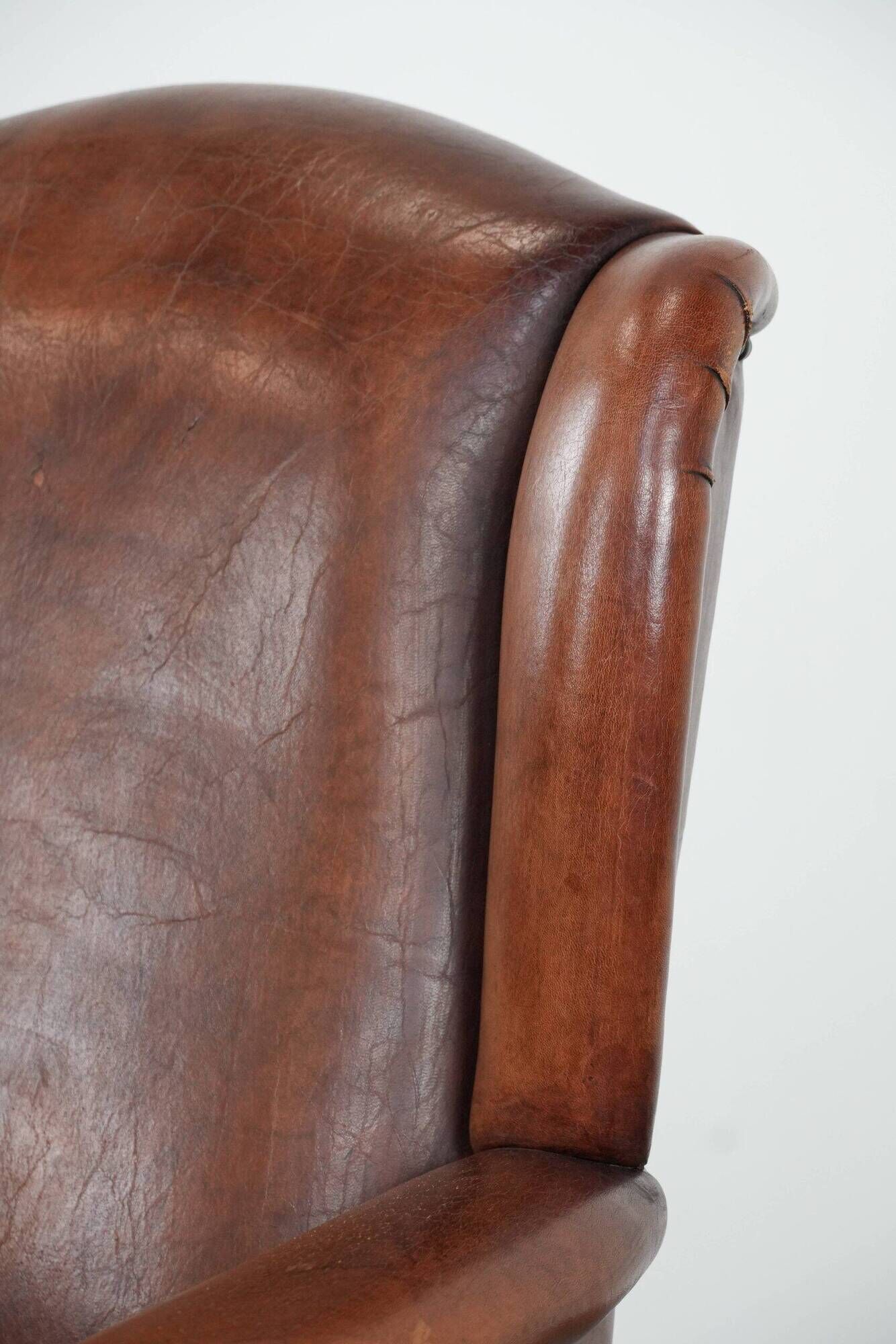 Classic vintage wingback chair in sheepskin and wood
