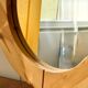 Round mirror in raw wood