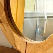 Round mirror in raw wood