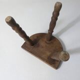 Old milking bench tripod stool in solid wood
