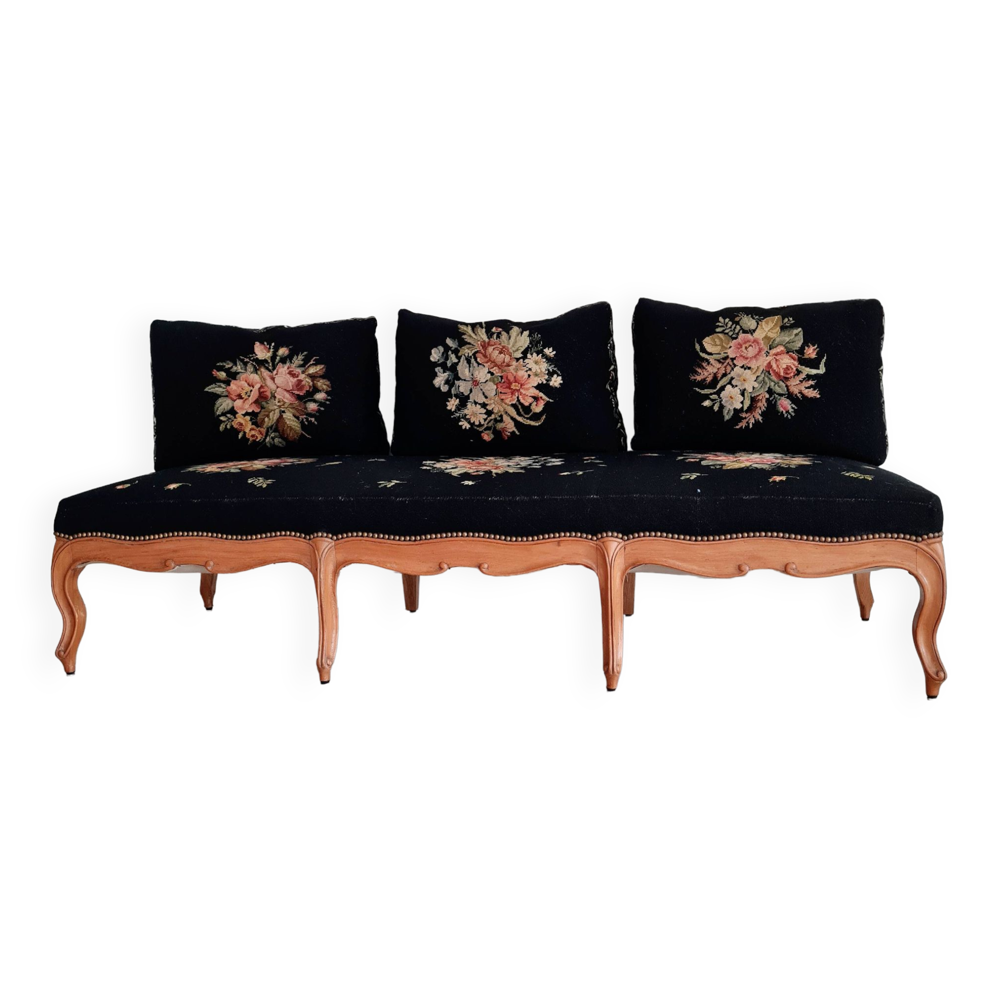 Old bench upholstered in black canvas flowers