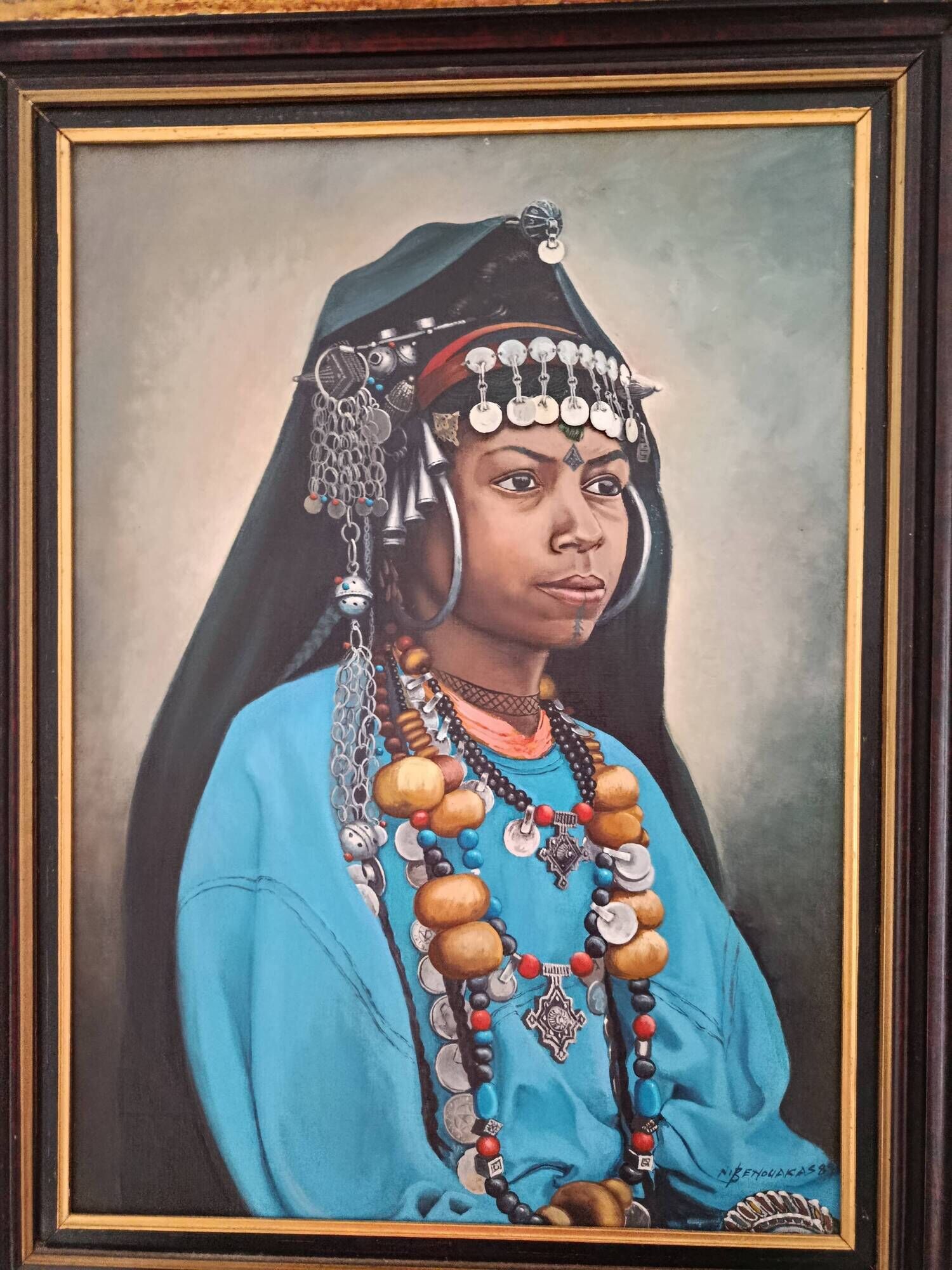 Portrait of a young Moroccan woman in traditional attire and adornments.