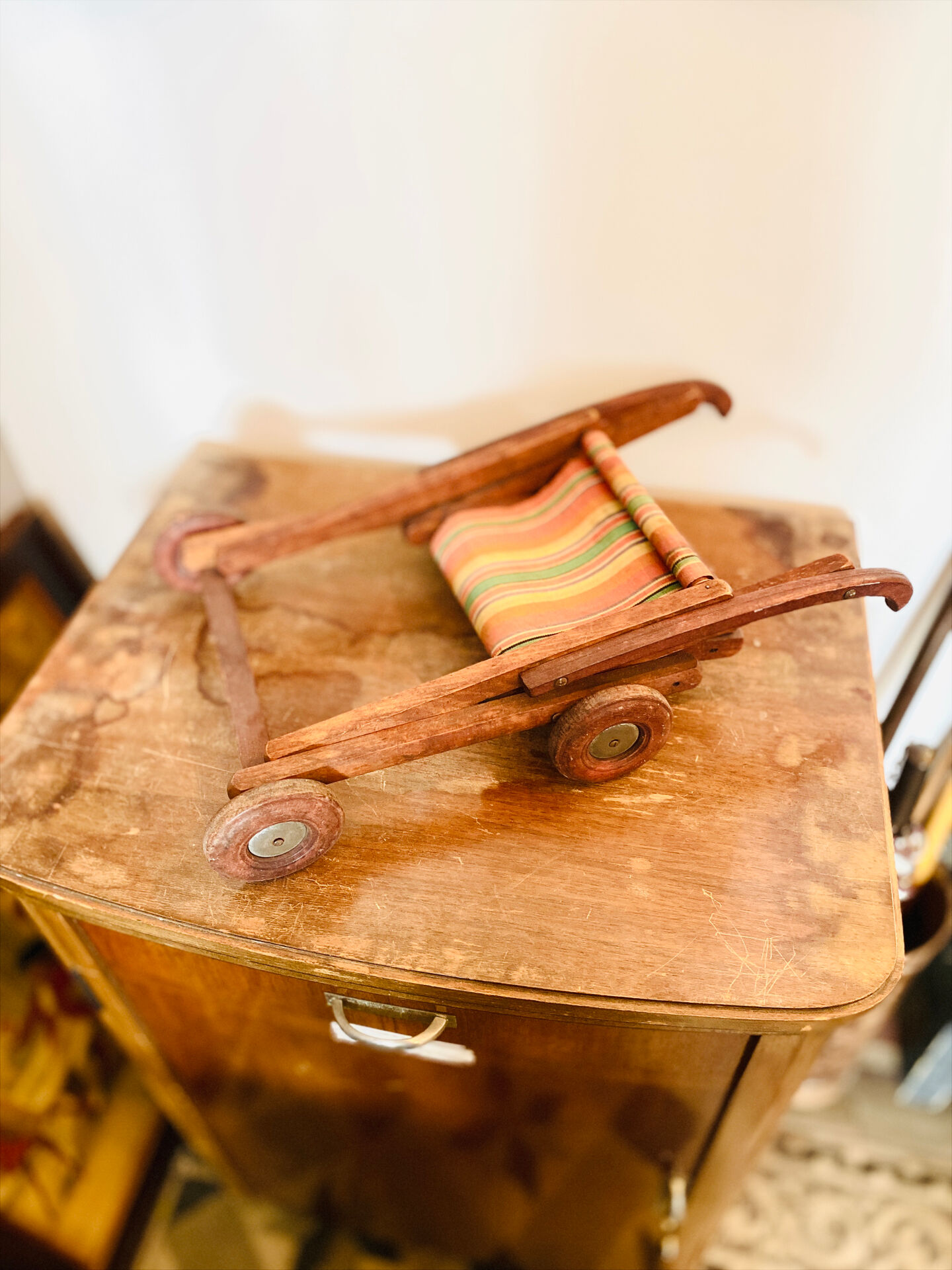 Vintage wooden folding doll's deckchair on wheels