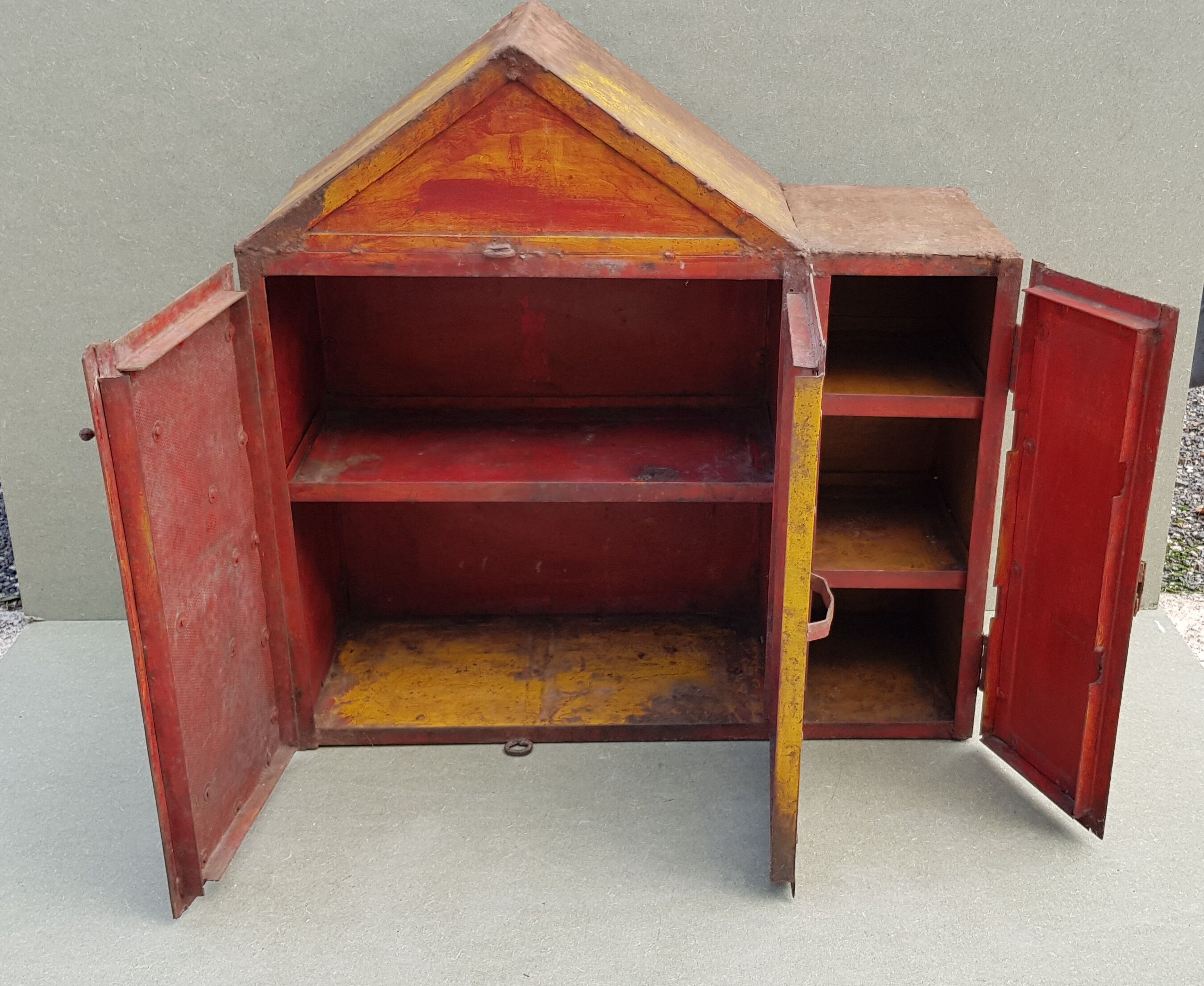 Old atypical metal workshop furniture with its original red patina