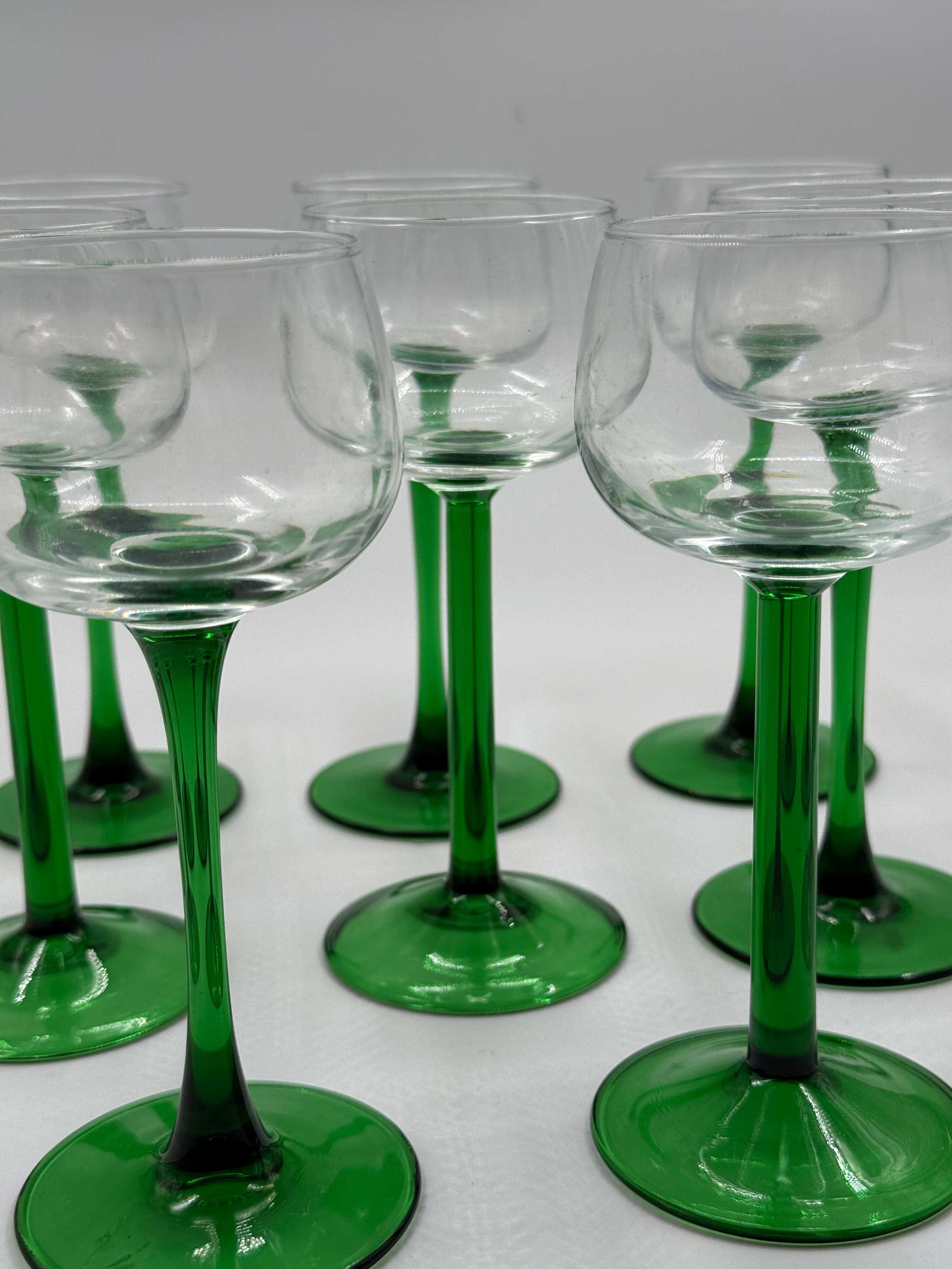 Set of 8 green stemmed wine glasses made in France.