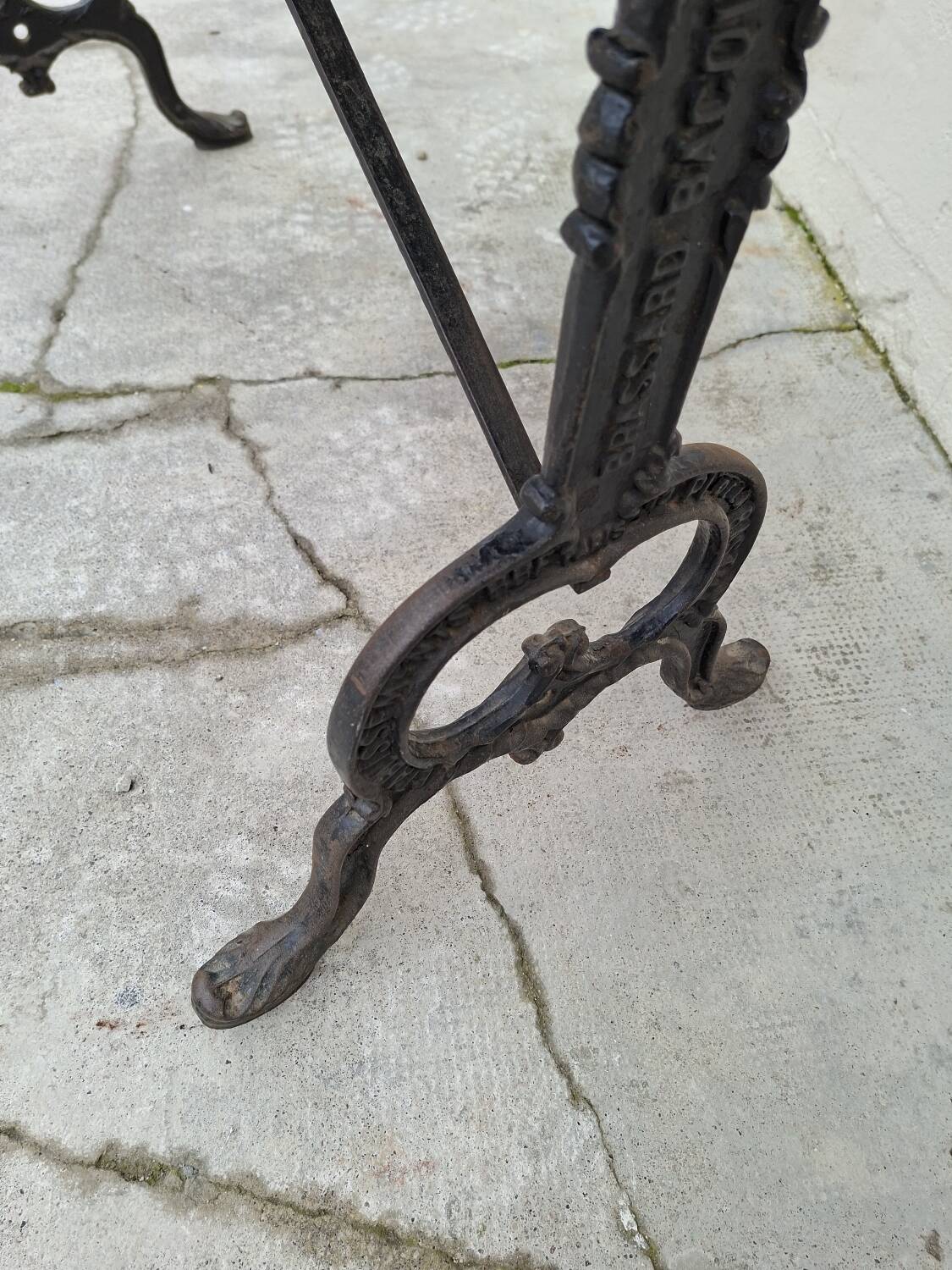Solid oak bistro table with a cast iron base, signed.