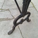 Solid oak bistro table with a cast iron base, signed.