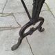 Solid oak bistro table with a cast iron base, signed.