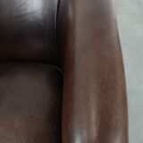 Stylish and sturdy dark brown club armchair made of sheepskin leather