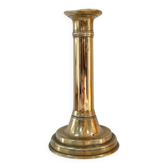 Old brass candlestick with push button.