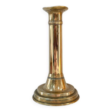 Old brass candlestick with push button.