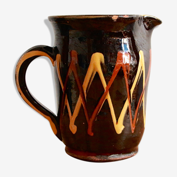 Pitcher in black and orange