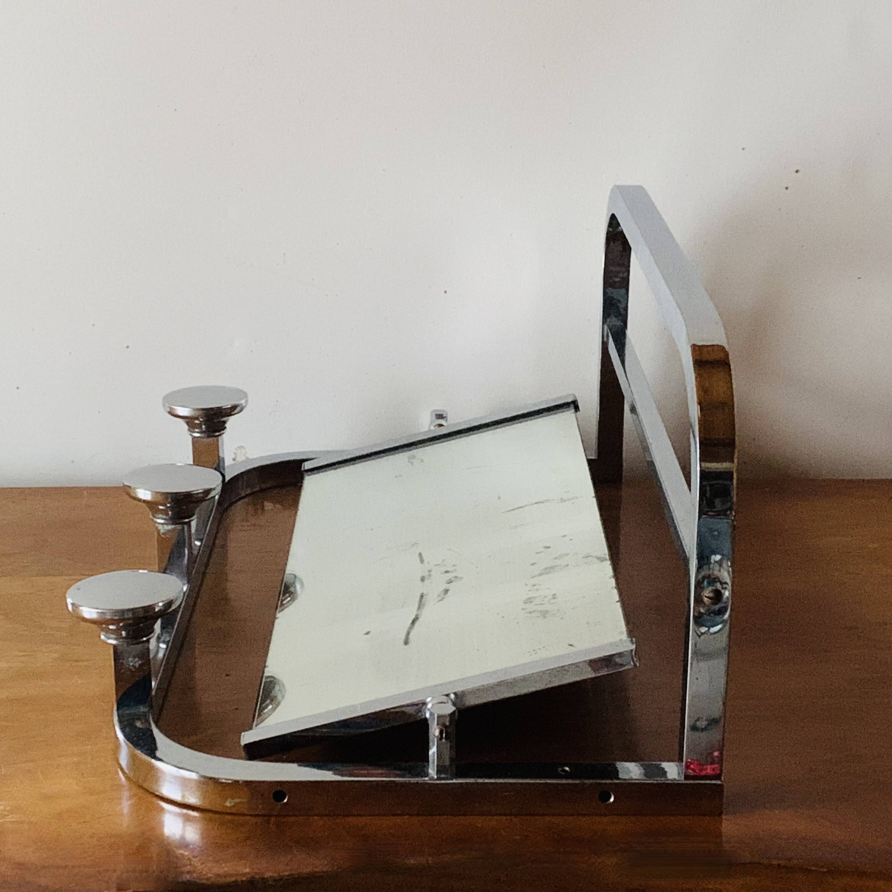 Vintage wall-mounted coat rack in chrome metal with integrated mirror and hat rack