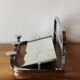 Vintage wall-mounted coat rack in chrome metal with integrated mirror and hat rack