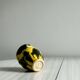 Small ceramic vase, yellow and green colors, artistic design,