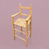 Old wooden and straw high chair for children