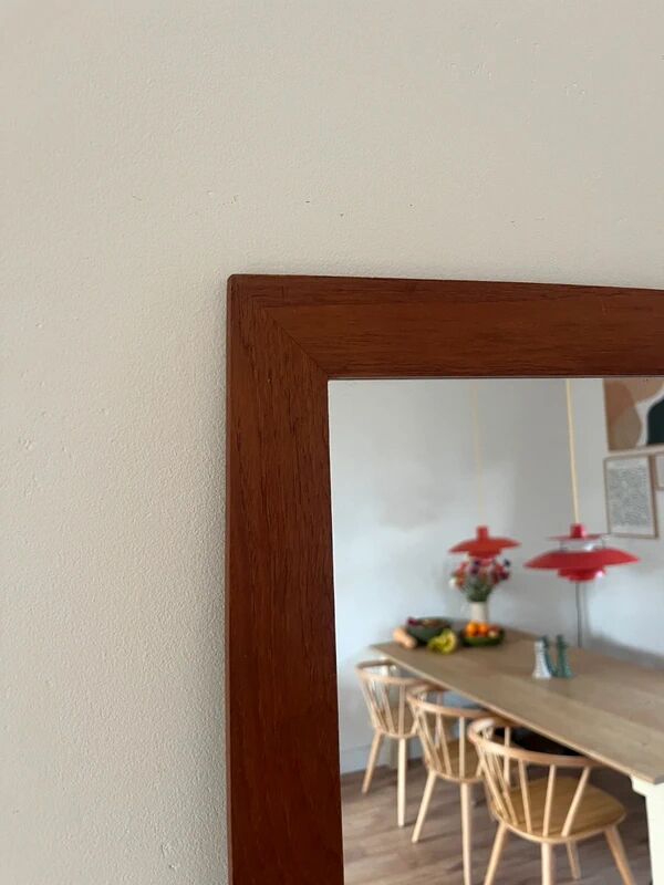 Vintage Danish teak mirror with a rounded back.