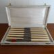 12 vintage stainless steel knives bone or bakelite sleeves in case