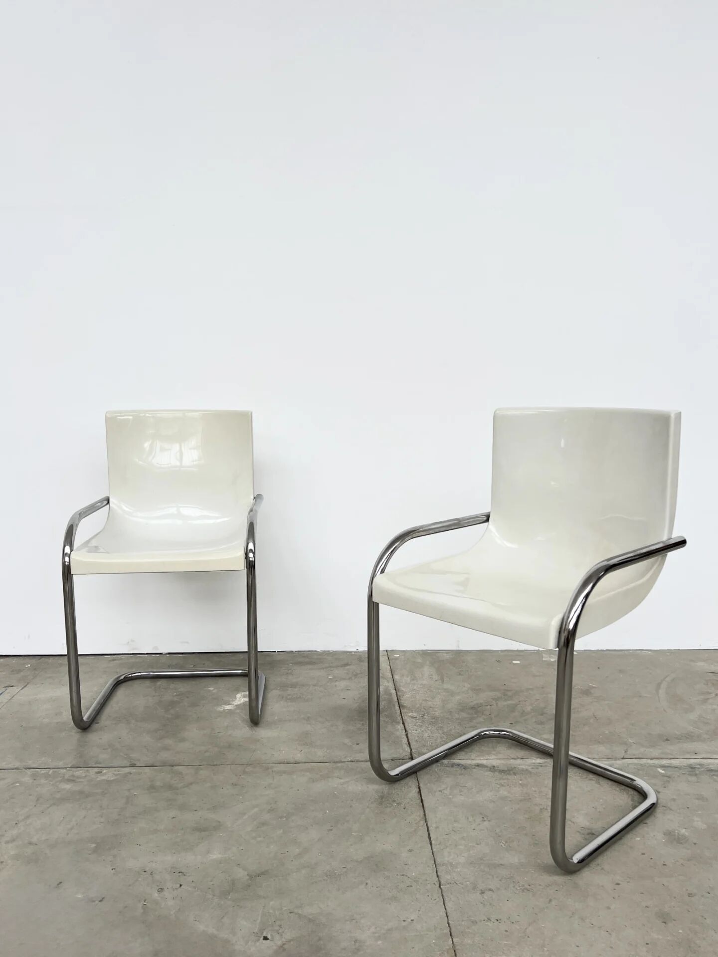Pair of white moulded shell chairs with chrome tube — Space Age 70s