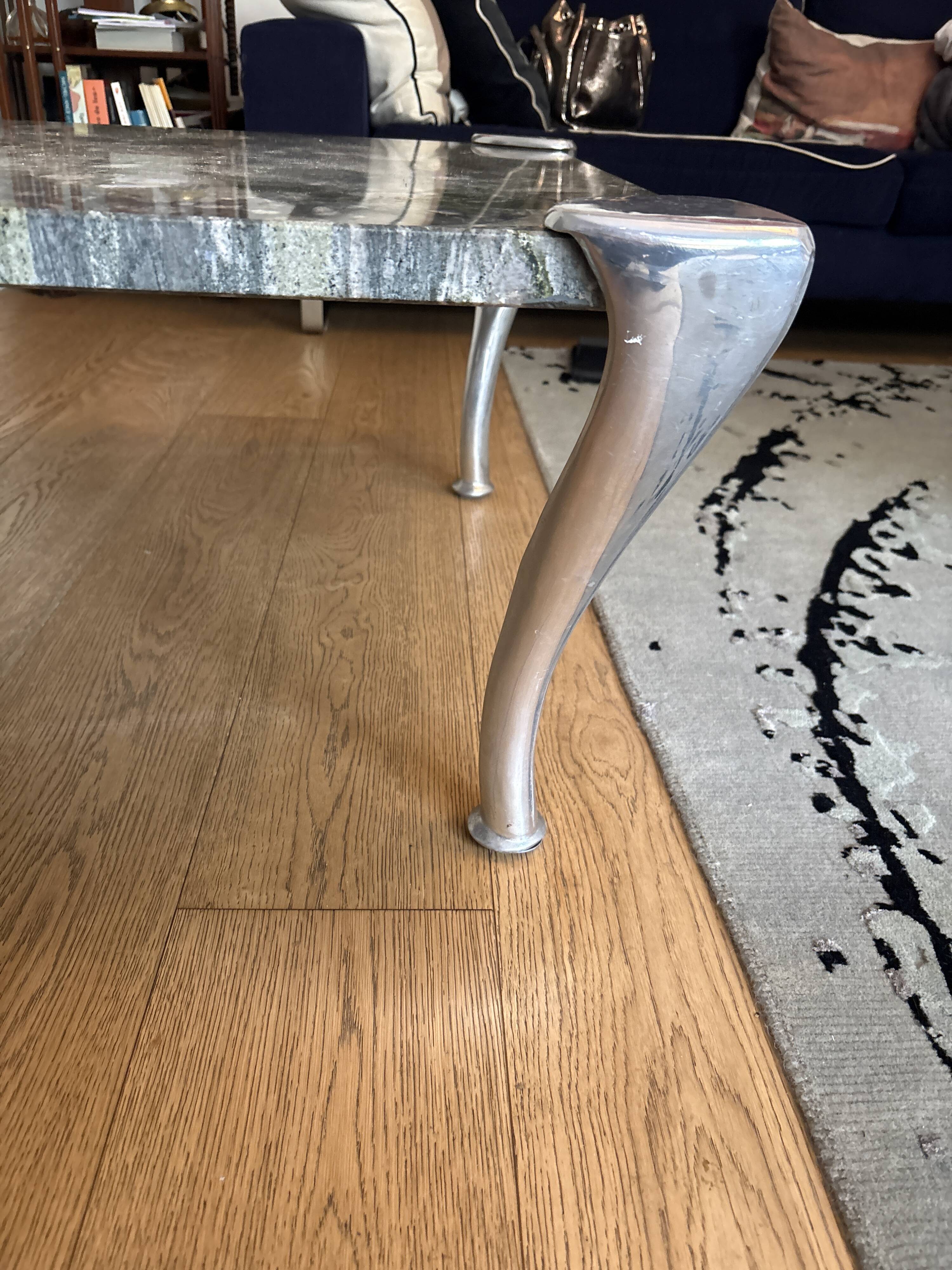 Contemporary coffee table with a marble top and steel base.