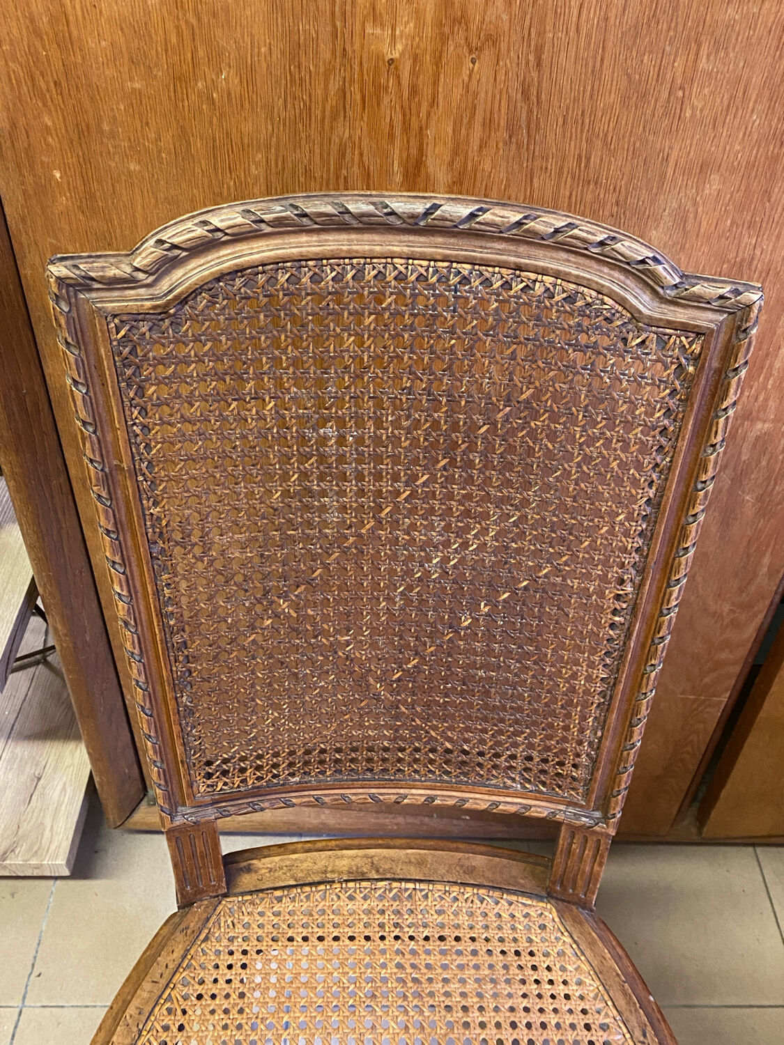 Chair with caned seat and back made of wood