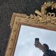 Large gold mirror in Louis XVI style with laurel crown, 121 cm.
