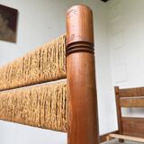 Brutalist style bed with chain and straw