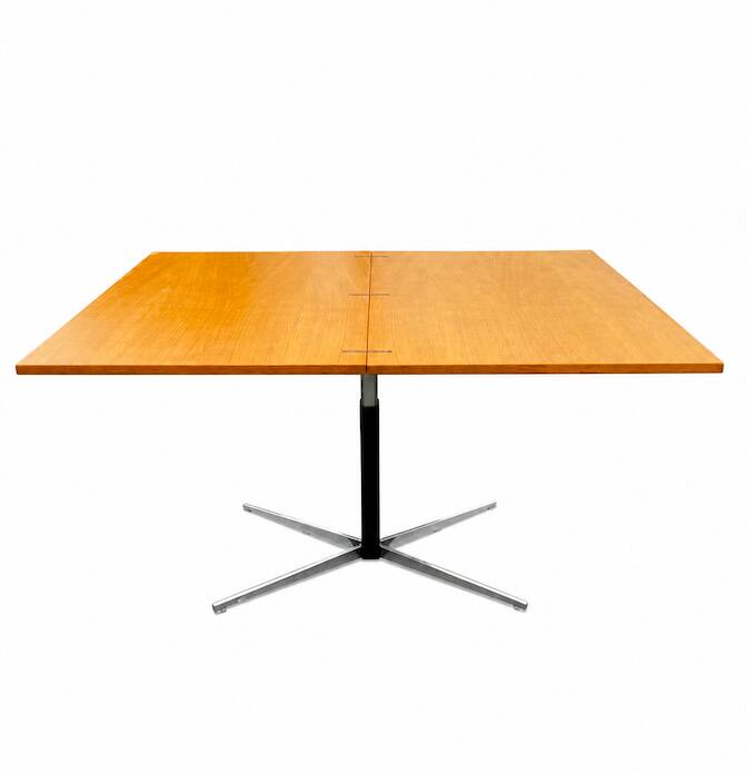 Table rises and lowers in light wood and metal.