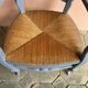Provencal style straw armchair with gray blue patina armrests