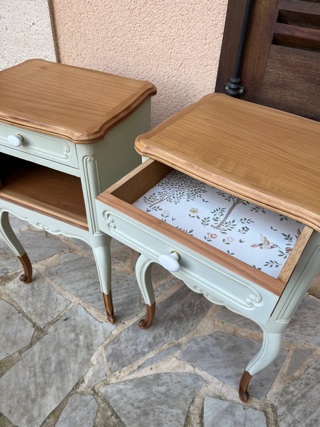 Renovated bedside tables in laurel green and light wood.