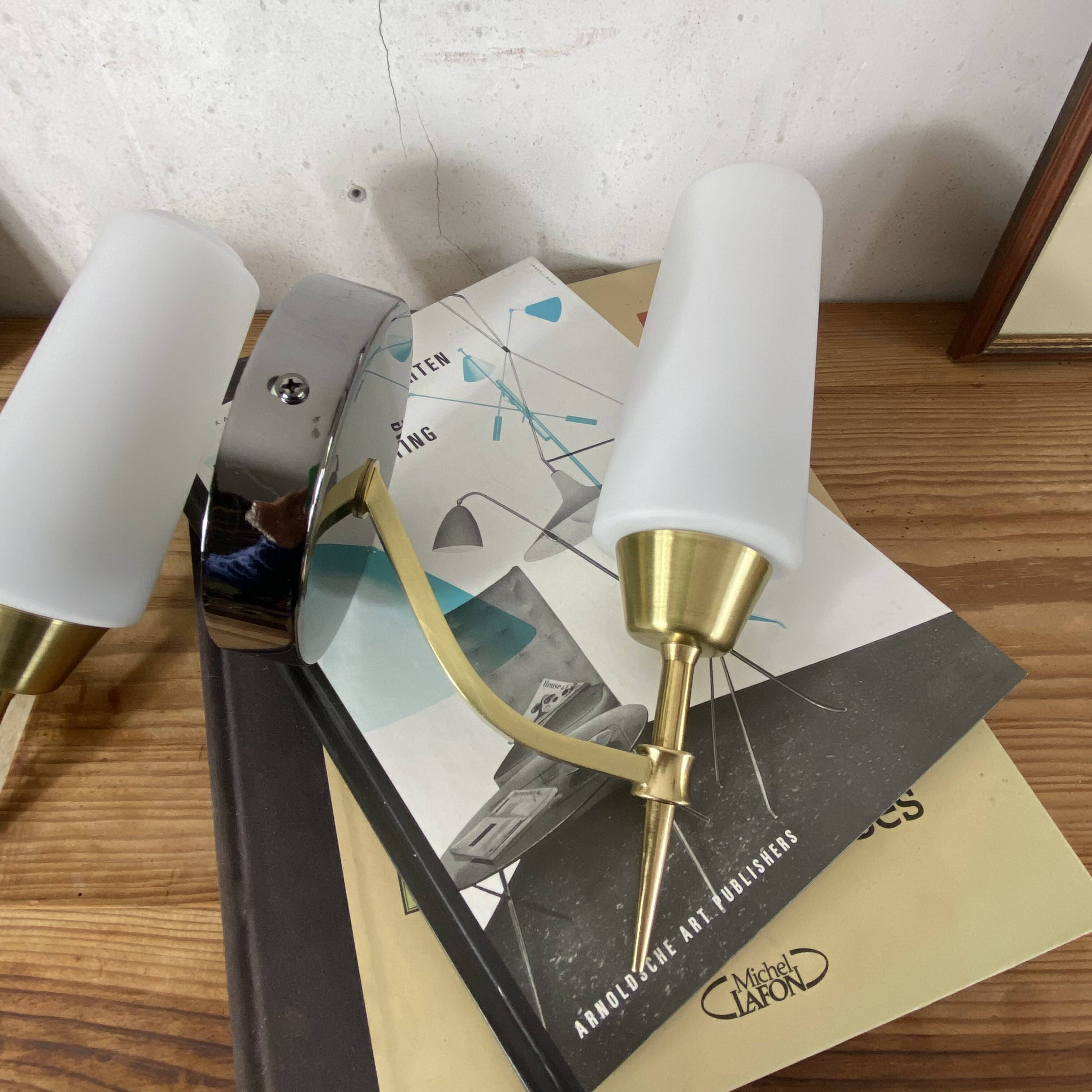 Pair of wall sconces in brass with white glass tulips.