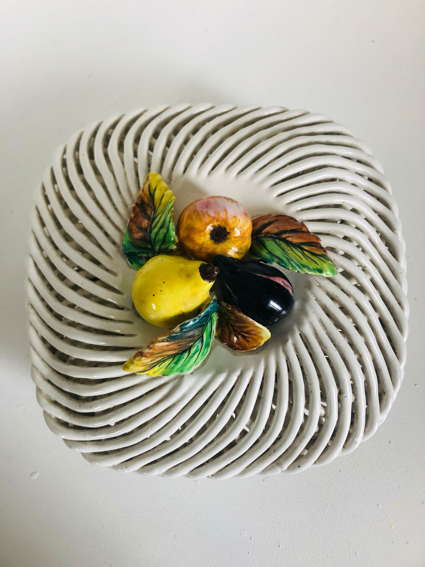 Covered basket in white woven ceramic and fruit slip.
