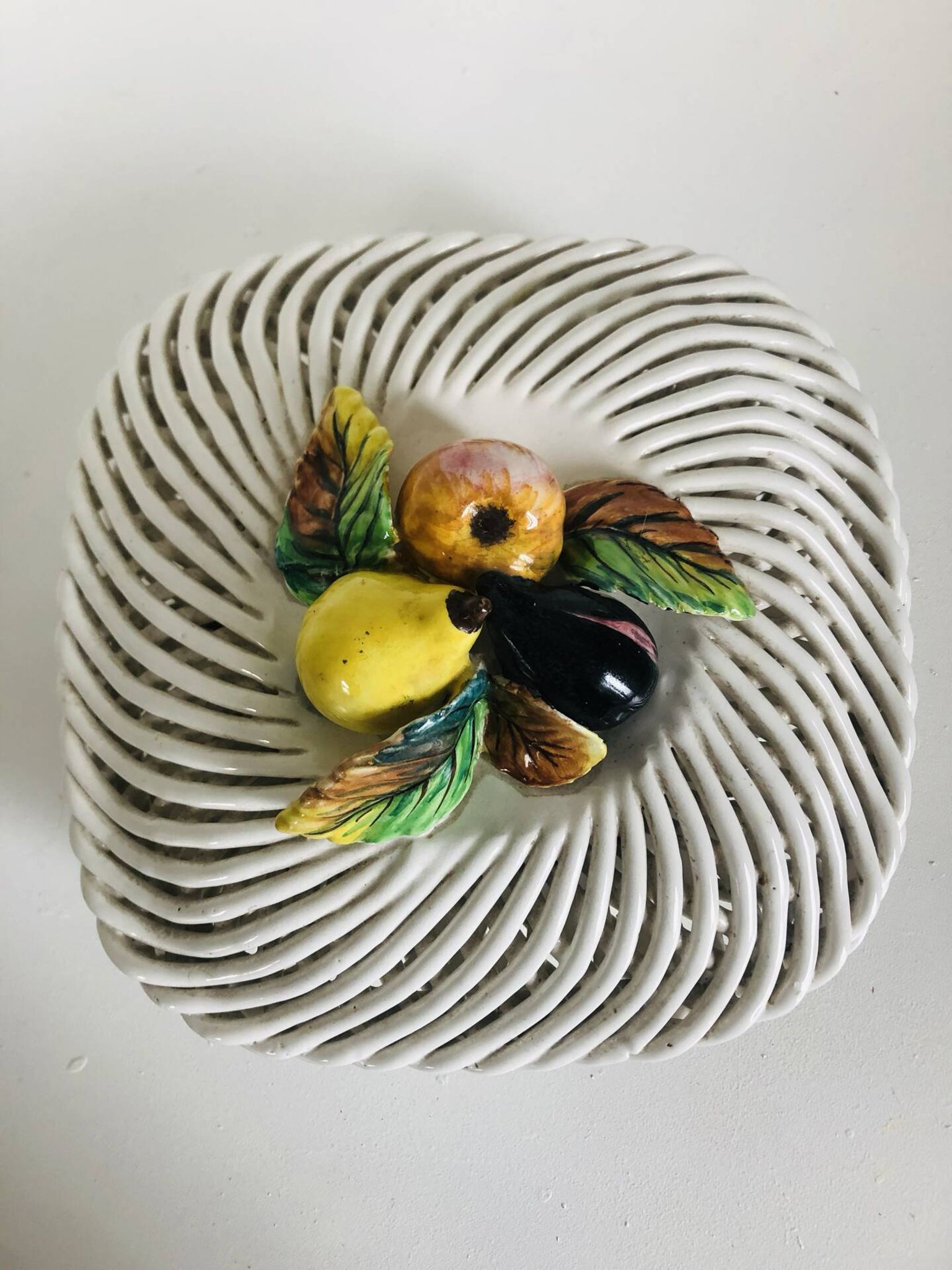 Covered basket in white woven ceramic and fruit slip.