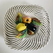 Covered basket in white woven ceramic and fruit slip.