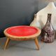 Wooden and red plastic compasses plant stand.