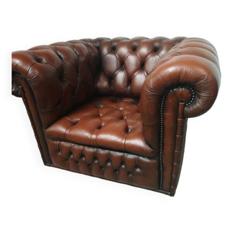 Brown padded Chesterfield armchair