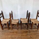 Series of 4 brutalist rustic chairs in carved wood straw seat