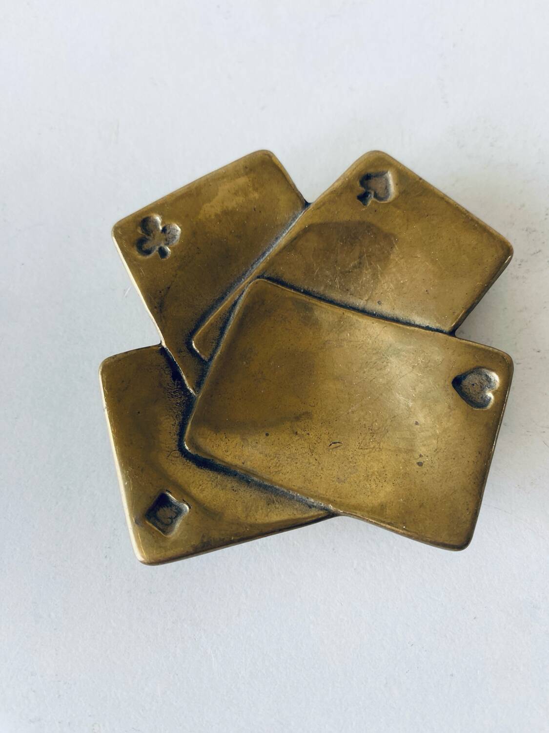 Empty pocket square of aces in brass