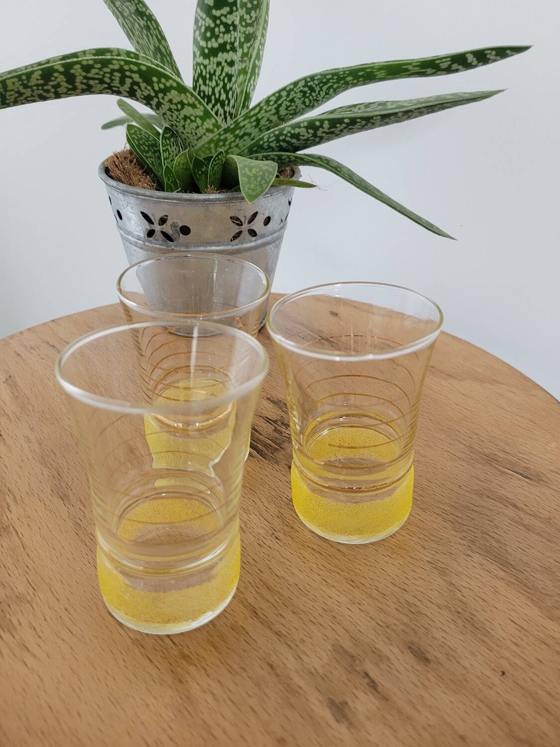 Trio of small yellow granite glasses with gold rims