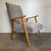 Vintage armchair reupholstered in light grey.