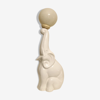 White ceramic table lamp, an elephant holding a lighted ball