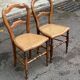 Two Louis Philippe cane chairs in solid carved wood from the 20th century