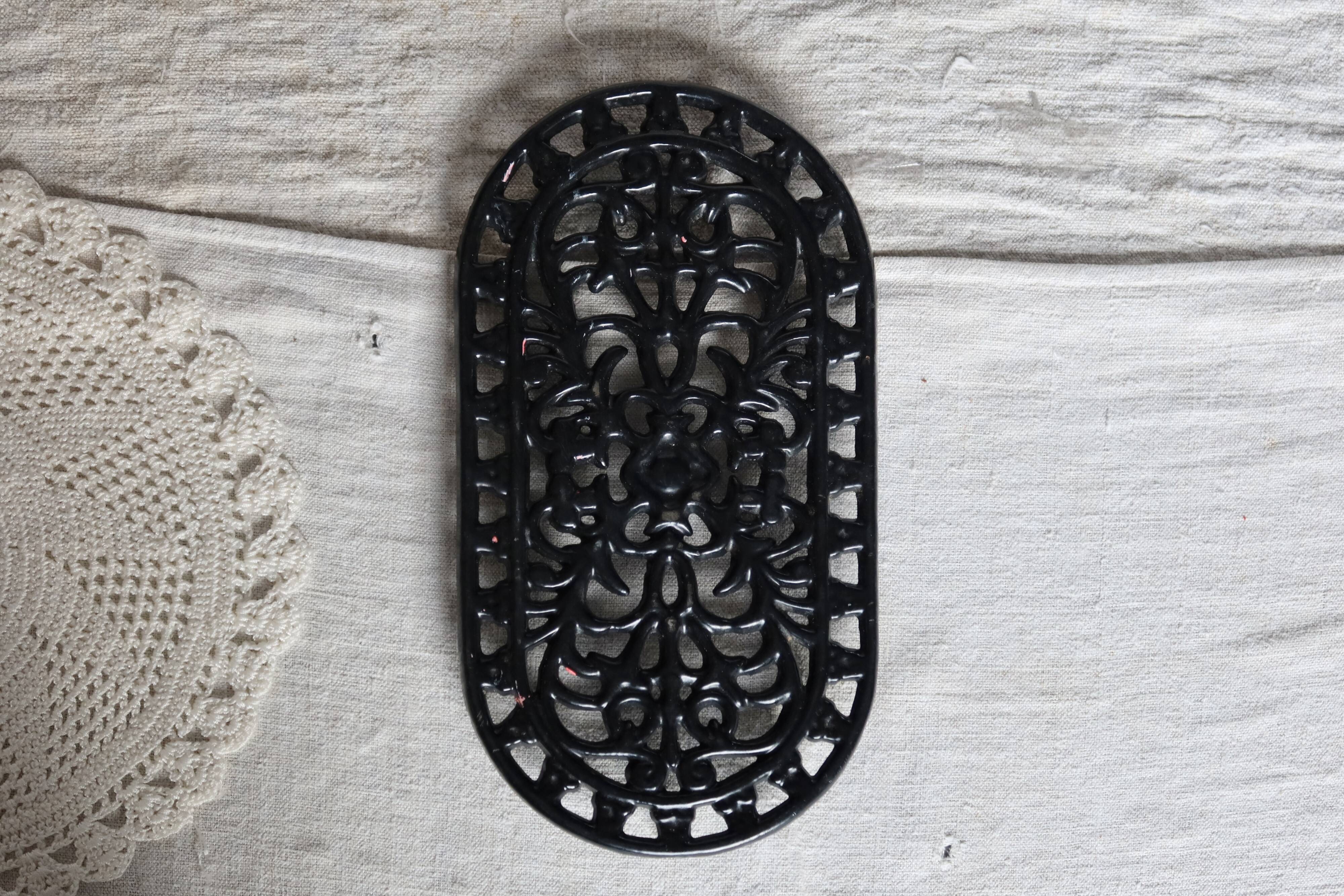 Vintage black cast iron oval trivet - Openwork design
