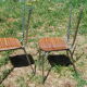Pair of formica chairs with chrome metal backs in the shape of a lyre.