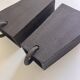 Pair of black stoneware graphic wall lights with handmade ring.
